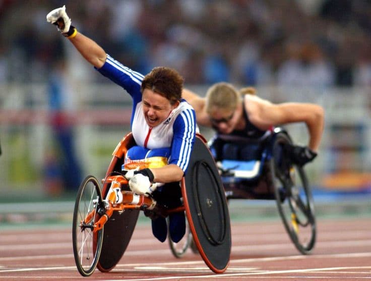 Wheelchair athlete racing on an outdoor athletics track