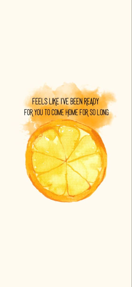 Singer performing on a large concert stage with atmospheric lighting and crowd