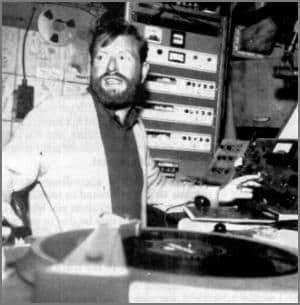 Massive outdoor music festival crowd with stage lights at night