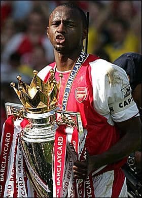 Premier League football match action with players competing for the ball