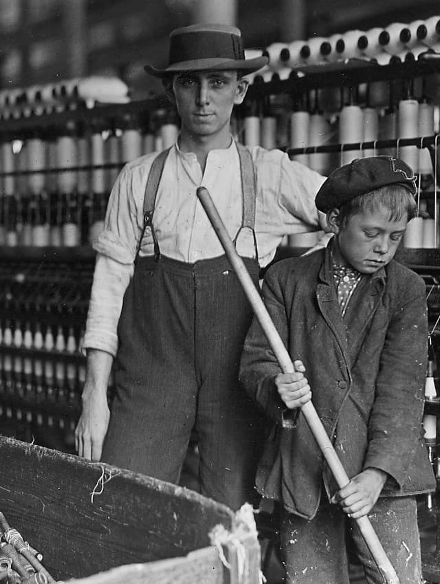 Person counting cash at a register in a small business