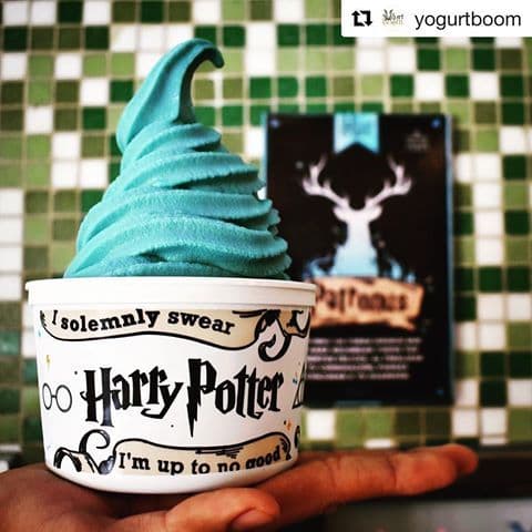 Solo female traveler with a backpack looking out over a scenic mountain landscape at sunrise