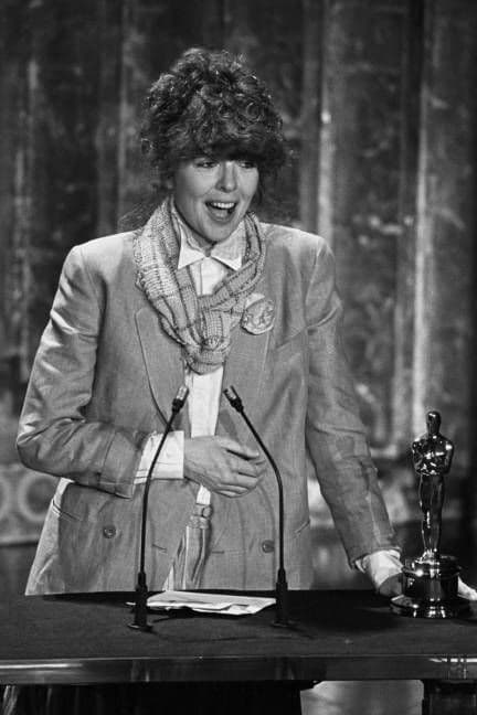 Golden Oscar statuette on a red carpet with dramatic lighting