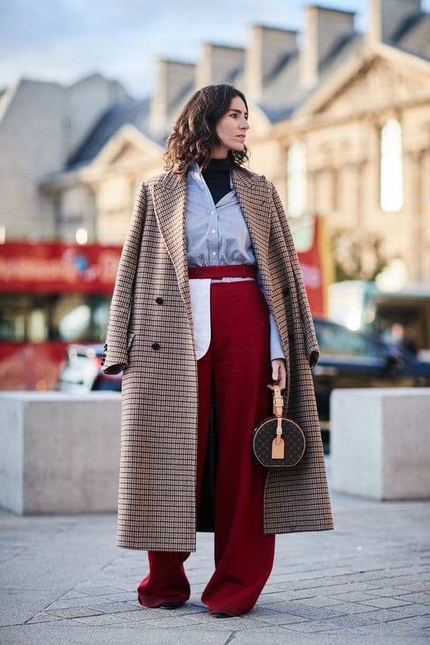 Spring fashion runway model wearing pastel earth-toned outfit with sustainable fabrics