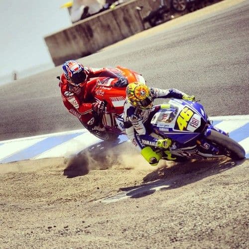 MotoGP motorcycle racing at speed on the Lusail International Circuit under floodlights