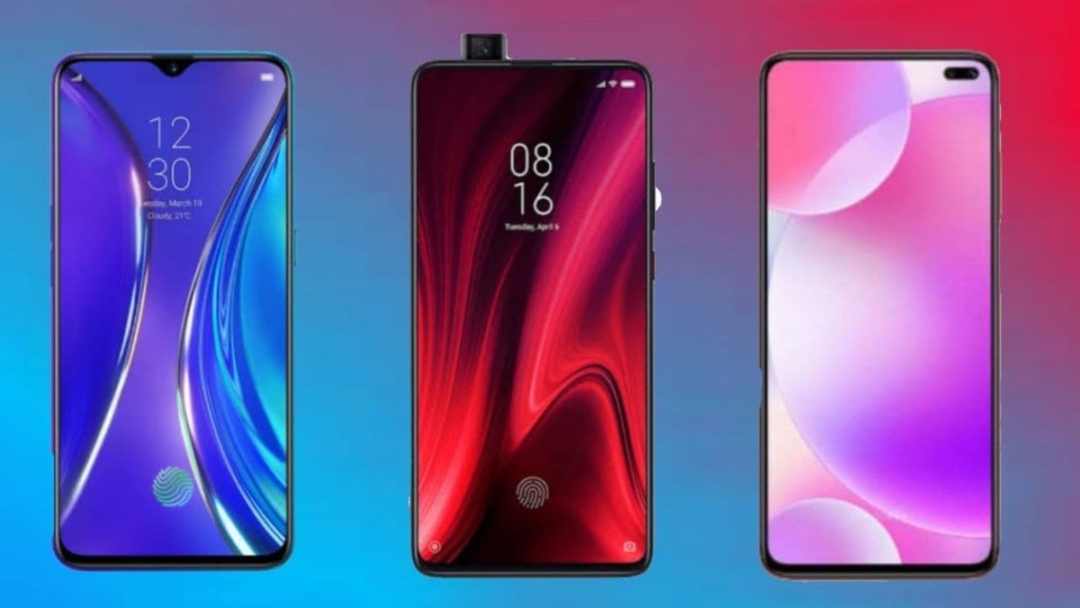 Several modern smartphones displayed on a wooden surface