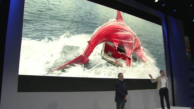 A large flat-screen television mounted on a wall displaying vivid colors