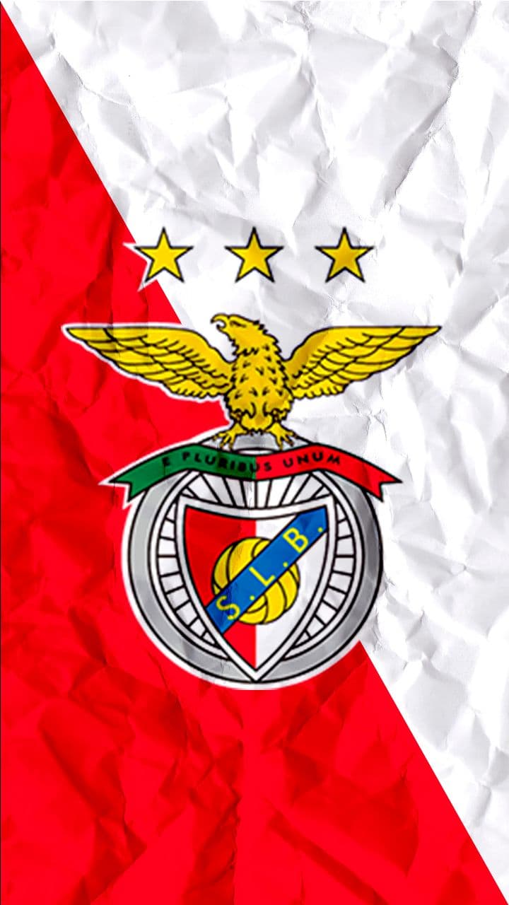 Football players competing on a green pitch under stadium lights