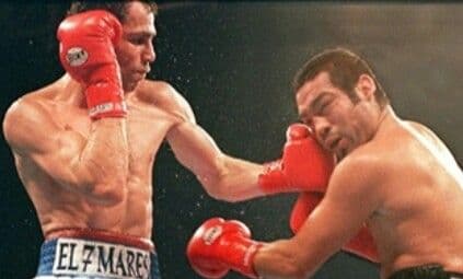 Boxing ring under bright lights in a large arena