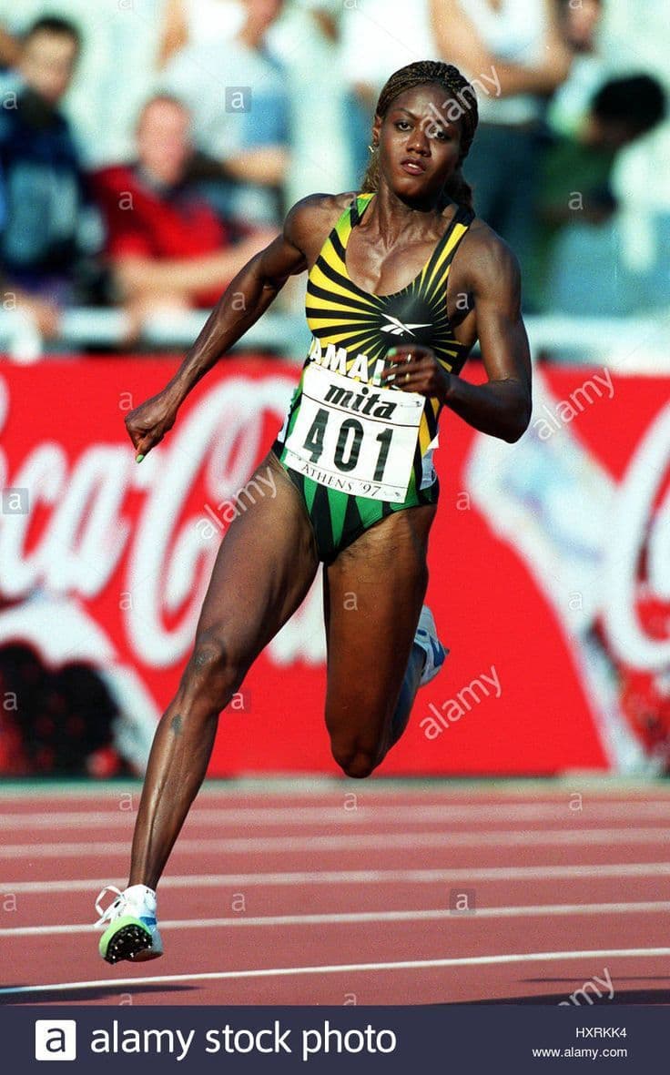 Athletes competing on an indoor athletics track