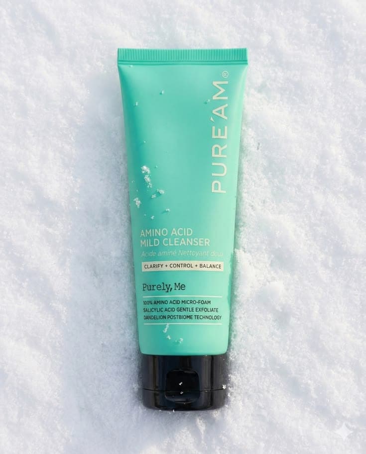 Close-up of minimalist skincare products arranged on a marble surface