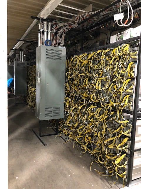 Server room with rows of blinking equipment