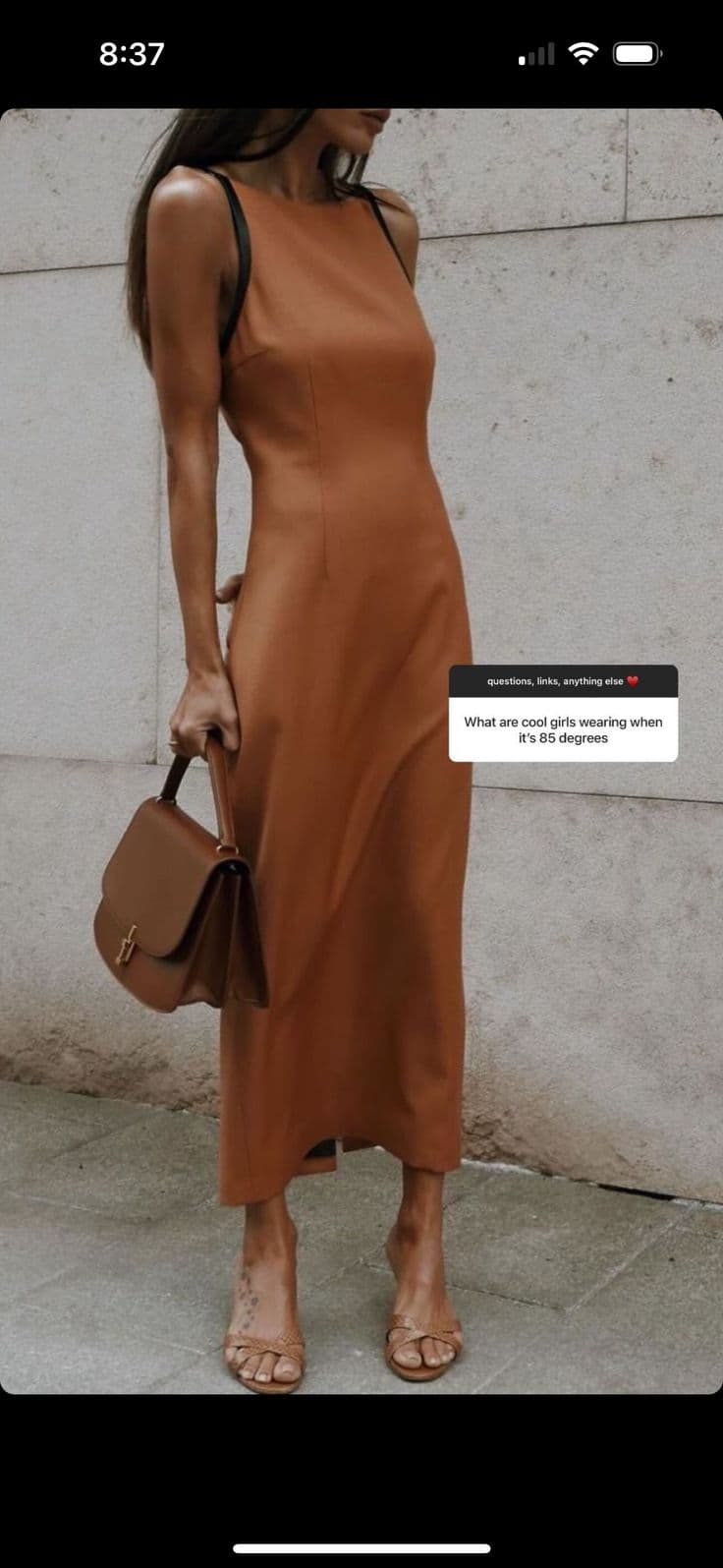 Colorful second-hand clothes hanging on a rack at a market