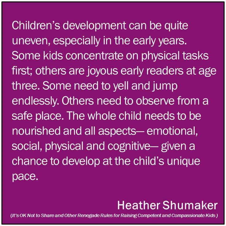 Young students working together on a coding project with colorful blocks on a laptop screen