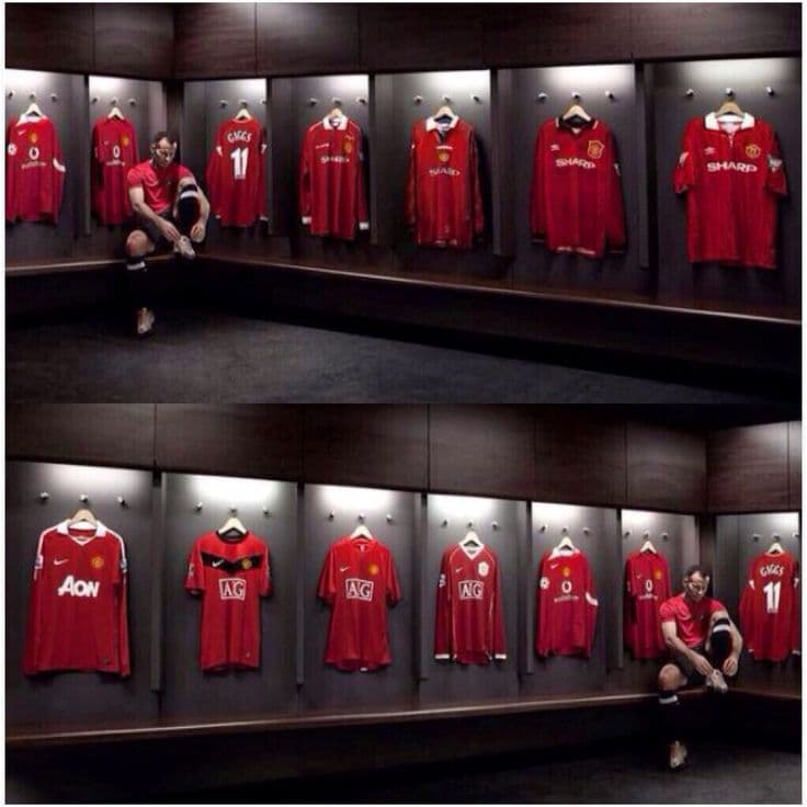 English football stadium with packed stands and green pitch