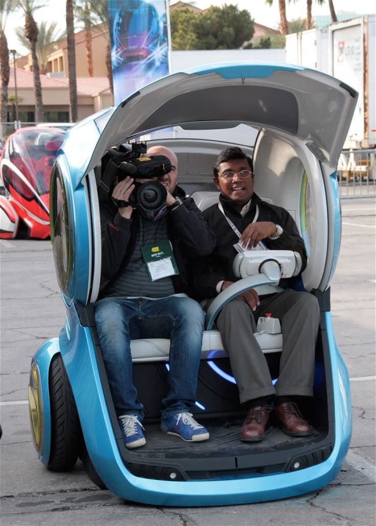 An electric vehicle plugged into a modern charging station in a well-lit parking area