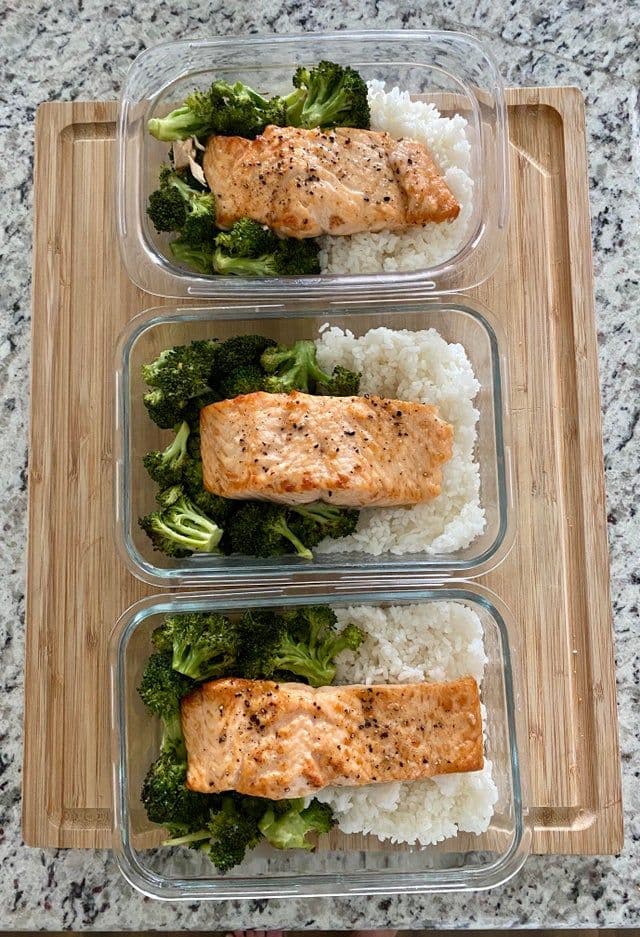 Colorful meal prep containers lined up on a kitchen counter
